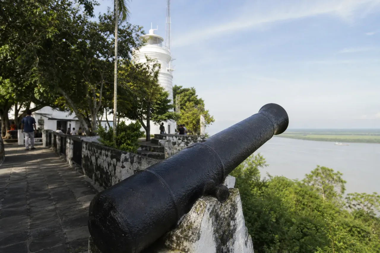 AI-created editorial interpretation of a historic cannon, lighthouse and estuary view at Bukit Melawati
