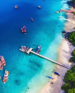 A beach and wooden jetty on the Perhentian Islands