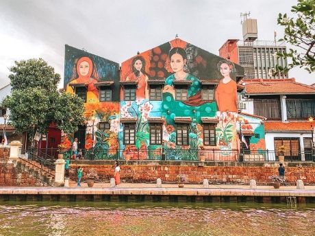 People gathering in a colourful Malaysian neighbourhood